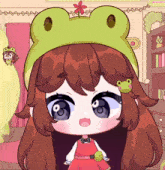 a girl wearing a frog hat with a flower on it