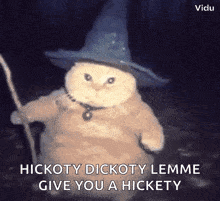 a cat is wearing a witch hat and holding a cane .