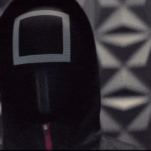 a person wearing a mask with a square in the middle