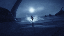 a woman in a blue dress is holding a sword in a dark scene