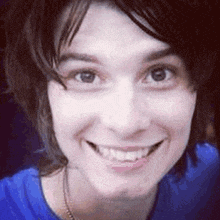 a close up of a woman 's face with a smile on her face .