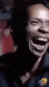 a close up of a person laughing with a dragon logo in the corner