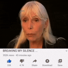 a woman with blonde hair is sitting in front of a screen that says " breaking my silence "
