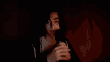 a man is holding a microphone and the word nan is on the bottom right