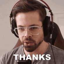 a man wearing glasses and headphones says thanks in white letters
