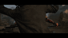 a man with blood on his shirt is holding a stick