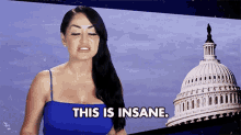 a woman in a blue top says this is insane