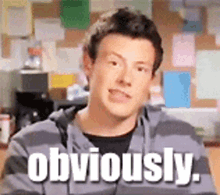 a man in a striped hoodie says obviously in white letters