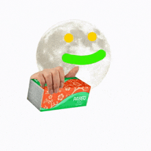 a person holding a package of paseo facial tissues