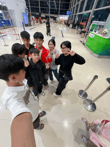 a group of people are posing for a picture in front of a green counter