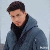 a man wearing a hooded jacket is featured on the cover of inslide