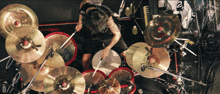a man playing drums with a zildjian cymbal in the background