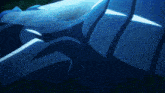 a close up of a blue and white object in a dark room
