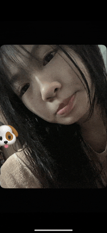 a close up of a girl 's face with a dog sticker on it