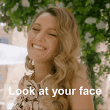 a woman is smiling with the words look at your face next to her