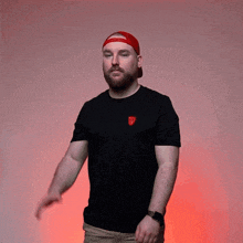 a man wearing a red hat and a black shirt with a red emblem on it