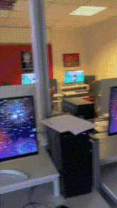 a blurred image of a room with a few computer monitors