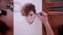 a person is drawing a man 's face with colored pencils including one that says prismacolor