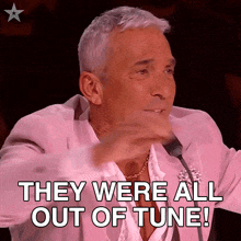 a man in a pink suit is saying they were all out of tune