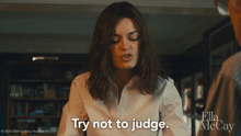 a woman says " try not to judge " in a ella mccay movie