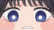 a close up of a girl 's eyes with a white circle in the middle of them