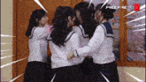 a group of girls are hugging each other in front of a window that says free fire x