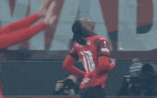 a blurred image of a soccer player with a camera behind him