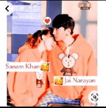 a man and a woman wearing matching hoodies are kissing each other