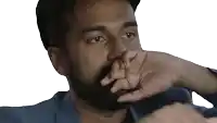 a man with a beard covering his face with his hand