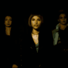 three women are standing next to each other in a dark room in a blurry photo .