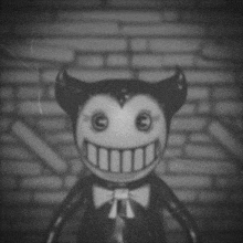 a black and white photo of a smiling cartoon character with horns