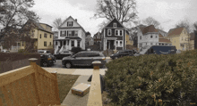 a blue amazon truck is parked in front of a row of houses