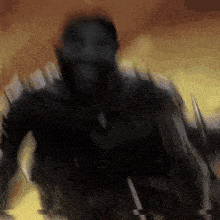 a blurry picture of a man in a black suit holding a sword in his hand .