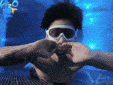 a man wearing goggles is in a pool with a h2o logo in the background