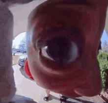a close up of a person 's face looking through a doorbell camera .