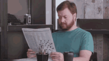 a man is reading a newspaper with a crossword puzzle on it