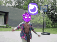 a man with a purple owl on his head stands in front of a basketball net