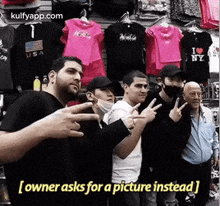 a group of men are standing next to each other in front of a store .