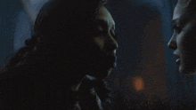 a couple of women looking at each other in the dark