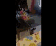 a blurry picture of a room with a table and a chair .