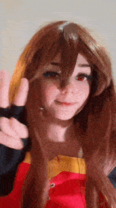 a girl with long brown hair and red eyes is giving a peace sign .