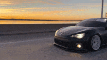 a black car with a sticker on the windshield that says ' toyota '