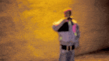 a blurry picture of a person standing in front of a wall