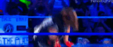 a wrestling match is taking place in a ring with a sign that says take time .
