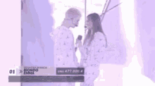 a man and a woman are standing next to each other and looking into each other 's eyes .