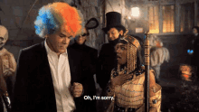 a man in a clown wig is standing next to a woman in a costume and says oh i 'm sorry