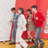 a group of people are dancing in front of a sign that says tvn on it
