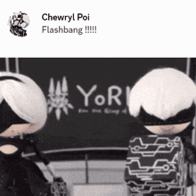 two dolls are standing in front of a sign that says yor