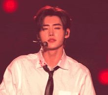 a man in a white shirt and tie with blood on his shirt