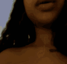 a close up of a woman 's chest with a white top
